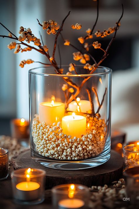 Cozy living room decor idea featuring a glass vase with lit candles, popcorn filler, and autumn branches, creating a warm fall ambiance. Pastel Fall Decor, Simple Fall Decor, Pastel Fall, Cooking Decor, Autumn Treats, Rustic Arrangements, Cheap Fall Decor, Decorate For Fall, Candle Diy