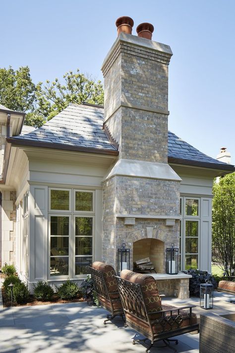 Set between floor-to-ceiling windows, this neutral brick fireplace adds elegance to a welcoming outdoor area from Reynolds Architecture, Design & Construction. #outdoorfireplace #patio #outdoorlounge Outdoor Fireplace Ideas, Transitional Fireplace, Design Fireplace, Outdoor Fireplace Designs, Fire Design, Backyard Fireplace, Transitional Home Decor, Outside Living, Fireplace Ideas