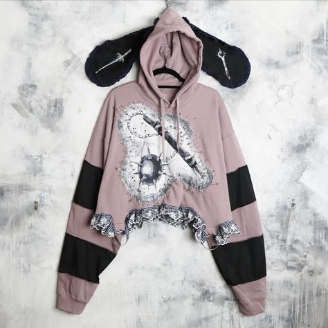 🗡️🐑 flail hoodie 🐑🗡️ I made 5 of these in sizes M - 4XL // dropping 15th june // 6pm UK time // these feature a dusty pink base and cropped fit, elongated patchwork sleeves, embroidered ruffle lace trim, O-ring hardware, about a million safety pins, flail drawings centre patch, ruffle trim bunny ears with weapon prints 🗡️🦷 Cute Diys, Bunny Ear, Creepy Cute, Safety Pin, Unique Charms, Dusty Pink, Lace Trim, Clothing Items, Lace