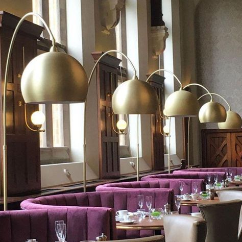 This bespoke arching floor lamp was designed for restaurant of hotel to sit over curved velvet booths. The metalwork was produced in our Satin Brass lacquer and a marble base was added adding not only essential weight to the fitting but and element of glamour. R&S Robertson know that your contract lighting has to be both stylish and functional and have amassed over 80 years experience in the sector. Get in touch with our Sales Office with any requirements - the team are on hand to assist Restaurant Booth With Lamps Built In To Frame, Arching Floor Lamp, Curved Sofa Restaurant, Curved Banquette Seating Restaurant, Arch Hotel, Brasserie Of Light London, Arch Lamp, Arch Light, Bold Rose Glod Floor Lamp