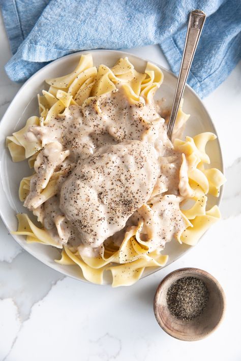 My dad's cream of mushroom pork chops are a family favorite. Made with pan-seared pork chops and cream of mushroom soup, this fast and easy weeknight dinner is best served with a side of egg noodles and sweet corn and is perfect for any family craving a little comfort food. Cream Of Mushroom Pork Chops, Smothered Pork Chops Recipe, Pan Seared Pork Chops, Mushroom Pork Chops, Seared Pork Chops, Apple Pork Chops, Crockpot Pork Chops, Smothered Pork Chops, Pork Ham