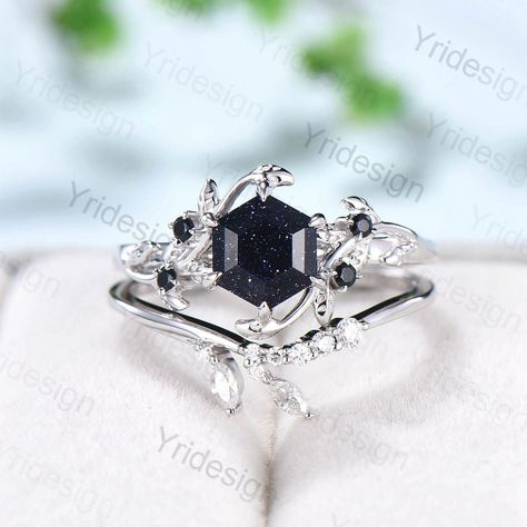 Blue Sandstone looks black when you see it from a distance. When you look close at it, you will see countless blue-purple grains on it.  Single blue sandstone engagement ring here: https://www.etsy.com/listing/1227573563/hexagon-blue-sandstone-ring-cute-vintage?click_key=d52926f4558cc0209047b6e668cd33baf6c5b5c8%3A1227573563&click_sum=c1169cb8&ref=shop_home_active_2&pro=1&frs=1 ≫≫ Item Details  Make every ring to order, all rings are handmade in the United States.  Metal: Solid 10K & 14K & 18K Go Engagement Rings Dark Stone, Black Sapphire Wedding Jewelry, Acotar Engagement Ring, Obsidian Engagement Ring, Dark Wedding Rings, Sandstone Wedding Ring, Black Rhodium Engagement Ring, Blue Sandstone Ring, Blue Sandstone Engagement Ring