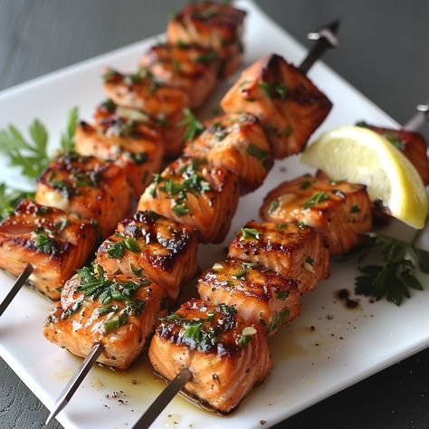 🐟 Grilled Salmon Kabobs: Delight in these flavorful salmon kabobs, perfect for a healthy, grilled treat. #GrillGoals Grilled Salmon Kabobs Ingredients: Salmon fillets, cubed (2 cups (300g)) Olive oil (2 tbsp (30ml)) Lemon juice (1 tbsp (15ml)) Garlic, minced (1 tsp (5ml)) Salt and pepper (to taste) Skewers Instructions: Marinate salmon in olive oil, lemon juice, garlic. Thread onto skewers. Grill until cooked through. 🔥 Fresh, flavorful, and fantastically grilled! #SalmonKabobScene Salmon Kebabs Skewers, Marinate Salmon, Grilled Salmon Kabobs, Salmon Kabobs, Salmon Skewers, Healthy Grilled, Salmon Spices, Simple Family Meals, Skewers Grill