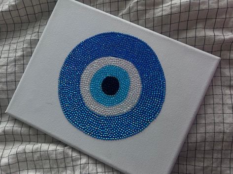 Protect your space with a touch of sparkle with our Evil Eye Rhinestone Canvas Art. Each stone is placed by hand to create a stunning piece for your home. Available in standard 8inx10in canvas. Perfect for birthdays, holidays, unique gifts, or even personal use. Gem Canvas Art Easy, Rhinestone Canvas Art, Evil Eye Wall Art, Rhinestone Canvas, Eye Wall Art, Art Mini Toile, Rhinestone Painting, Evil Eye Art, Glitter Wall Art