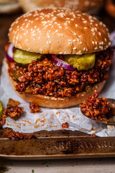 These Vegan Sloppy Joes are the ultimate comfort food, with hearty vegan beef crumbles coated in a sweet yet savory BBQ sauce. The filling is served on soft buns with crunchy bread and butter pickles. This easy-to-make, nostalgic dish is perfect for a comforting weeknight meal! Made with homemade TVP ground 'beef' crumbles, although you can substitute in cooked lentils. Vegan, vegetarian, plant based and meatless. Vegetarian Sloppy Joes, Tvp Recipes, Lentil Sloppy Joes, Vegan Sloppy Joes, Vegetarian Sandwich Recipes, Vegan Ground Beef, Vegetarian Bbq, Vegan Beef, Sloppy Joes Recipe