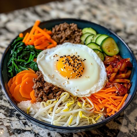 🥢 Dive into the flavors of Bibimbap! 🌶️ #KoreanCuisine #Bibimbap Bibimbap (Mixed Rice) Ingredients: Cooked rice (2 cups) Bean sprouts (1 cup, blanched) Carrot (1, julienned) Spinach (1 cup, blanched) Zucchini (1, julienned) Shiitake mushrooms (1 cup, sliced) Ground beef (1/2 cup, cooked) Kimchi (1/2 cup) Gochujang (2 tbsp) Sesame oil (1 tbsp) Sesame seeds (1 tbsp) Fried egg (1) Instructions: Arrange rice in a bowl. Place vegetables, beef, and kimchi on top. Add gochujang, sesame oil, and ... Kimchi And Rice, Bibimbap Bowl, Kimchi Rice, Mixed Rice, Food Pic, Korean Rice, Instagram Recipes, Kimchi Fried Rice, Twisted Recipes