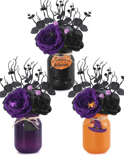 PRICES MAY VARY. Package Includes -- You will receive 3pcs mason jars tied with jute twine and 3pcs wooden slices, 3pcs spooky tree branches, 3pcs artificial purple roses, 3pcs artificial black roses, 3pcs spiders, 6pcs glitter decorative balls, and 15pcs black eucalyptus leaves. These rustic centerpieces decor for tables are great for decorating your home. Halloween Floral Mason Jar Centerpieces Decor -- So charming for a table centerpiece on the coffee table, bookshelf, bathroom countertop, ki Spooky Flower Arrangements, Diy Halloween Centerpieces, Halloween Centerpiece Ideas, Kids Centerpieces, Pink Table Decorations, Halloween Floral Arrangements, Black Centerpieces, Halloween Centers, Halloween Bathroom