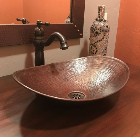 SimplyCopper 18" x 11-1/2" oval Canoa design is a unique design piece, created of 17-gauge copper which is hand-hammered to provide a elegant look. The finish is done by firing a dark patina, then brushing to highlight the undertones of copper in the sink. This sink is installed as a vessel. Sedona House, Vessel Sinks Bathroom, Copper Sink Care, Bucket Sink, Copper Vessel Sinks, Copper Sinks, Copper Sink Bathroom, Interior Hotel, Copper Vessel