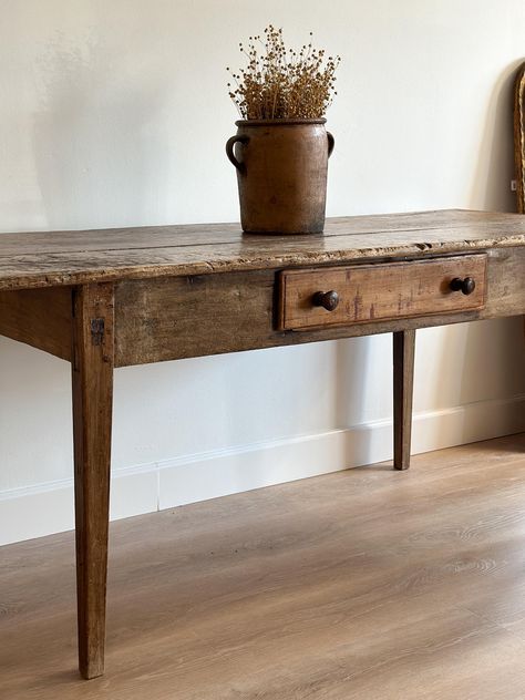 An incredible antique French work table that we had a hard time listing. Sturdy with extensive patina and texture complete with a double knob center drawer. This piece would be stunning as a dining table or a statement piece as a large console. Approximate dimensions: - 73.5" long - 30" deep - 31.5" tall - Floor to bottom of apron: 24" **Due to the unique antique and vintage nature of our pieces, all sales are final and sold as is. Our items are one-of-a-kind and can have wear consistent with ag French Kitchen Prep Table, Antique French Dining Table, Kitchen Prep Table Antique, Antique Wood Table Island, Antique Gate Leg Table, Antique Farm Table, Old Wooden Table, Raw Wood Table Kitchen Antique Dutch, French Country Dining Table