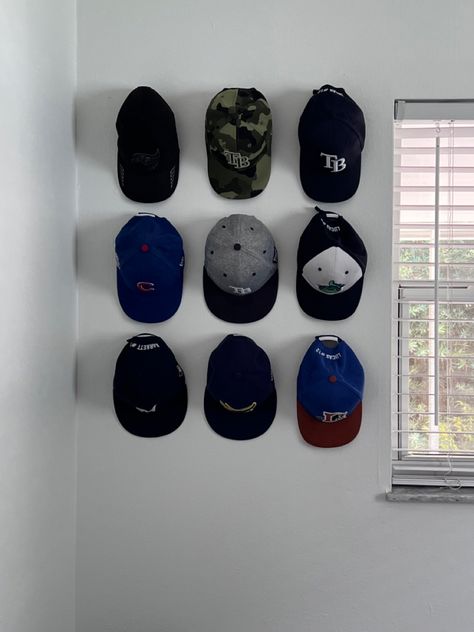 Hat Hanger Ideas Baseball Caps, Hanging Caps On Wall, Hats On The Wall Decor, Hats Hanging On Wall, Cap Organization Ideas, Hat Organization Wall, Cap Display Ideas, Hats On Wall, Hat Wall Display