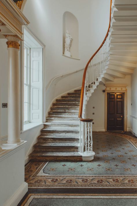 The hotel's "festival" concept includes workshops (glassblowing, pottery, bread making), yoga, co-working spaces, a cinema, an on-site organic farm, and a wellness space. Memberships are available for regular frequenters. #staircase #staircases #staircasedesign #repurposed #reclaimedwood #reclaimedstaircase #restored #restoredstaircase #restoration #regal #regalhome #oldhome #oldstaircase #oldstaircases #hotels #hotelrooms Hotel Staircase, English Mansion, Countryside Hotel, Georgian Buildings, Houghton Hall, Georgian Mansion, Old Mansions, Room Screen, Private Dining Room