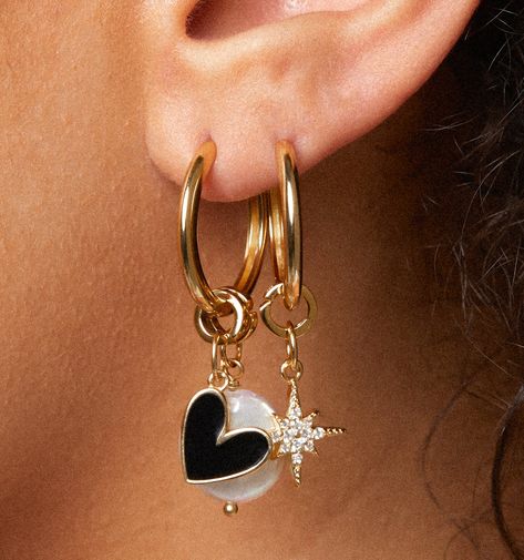 The cutest earring sets that you can mix, match and wear all at once! A charmed life. Wear them many ways to match your vibe for the day. This set comes with two statement pearl charms, a north star charm, and a heart charm. These gold hoops are for all occasions! Simple, modern, but still statement-making. Our hoops feature a hinged closure, so they are very secure and super easy to put on and off. You can sleep, shower, and hang in them all day long. Hoop size: 20mm, 2mm widthPearl charms: 14mmHeart charm: 13mmStar charm: 13mm Hoop Earring With Charm, Hoop Earring Charms, Hoop Charms, Earring Sets, Jewelry Lookbook, Sell Gold, Pearl Charms, Charm Set, Dangle Charms