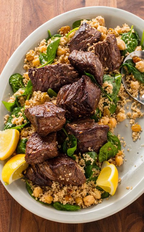 Moroccan Steak Tips and Couscous: Our Moroccan Steak Tips and Couscous recipe is the perfect weeknight one-pan meal that is anything but boring. Warm spices like cinnamon and cumin liven up quick-cooking sirloin while chickpeas, couscous, and spinach complete the meal. Moroccan Beef, Steak Tips, Moroccan Recipes, Couscous Recipes, Arabic Recipes, Country Magazine, America's Test Kitchen Recipes, Dish Ideas, Middle Eastern Food