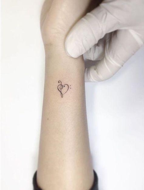 Over The Heart Tattoos For Women, Music Heart Tattoo Designs, Bass Clef Treble Clef Heart Tattoo, Treble And Bass Clef Heart, Treble Clef And Bass Clef Tattoo, Treble Bass Clef Tattoo, Treble Bass Clef Heart Tattoo, Treble Clef Bass Clef Tattoo, Bass And Treble Clef Tattoo