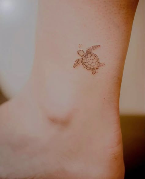 Hand Turtle Tattoo, Tiny Tattoo Turtle, Small Sea Turtle Tatoos, Turtle With Bubbles Tattoo, Sea Turtle Tattoo Behind Ear, Micro Sea Turtle Tattoo, Lil Turtle Tattoo, Turtle And Fish Tattoo, Turtle Ankle Tattoos For Women