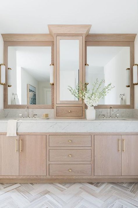 Fixed against a white and gray herringbone floor, a light brown brushed oak bath vanity is adorned with brass pulls and a marble countertop. Gray Herringbone Floor, Oak Vanity Bathroom, Oak Bathroom Vanity, Oak Bathroom, Bathroom Redesign, Transitional Bathroom, Master Bath Remodel, Bathroom Redo, Wood Bathroom