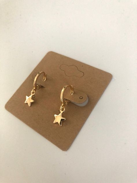 Small gold huggie hoops with dangling star charm. Lever back closure. 18K plated gold helps reduce sensitivity and make them hypoallergenic. Very lightweight style of earring that does not pull on ears at all. Simple style goes with every outfit! Cute Hoops Earrings, Gold Huggie Earrings With Charm, Trendy Hoop Earrings With Star Charm For Gift, Everyday Dangle Huggie Earrings With Star Charm, Trendy Gold Hoop Earrings With Star Charm, Gold Plated Hoop Earrings With Star Charm, Everyday Gold Star-shaped Hoop Earrings, Star Shaped Hoop Earrings With Dangling Charms For Gift, Star-shaped Hoop Earrings With Dangling Charms For Gift