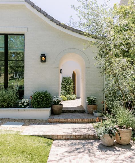 Inside Designer Nicole Green’s Orange County Home | Jenni Kayne Bohemian Home Exterior, Spanish Farmhouse Exterior, Brown Interior Doors, White Stucco House, Spanish Farmhouse, Family Backyard, Landscaping Retaining Walls, Stucco Homes, Jenni Kayne