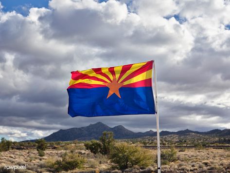 The Arizona state flag flies along old U.S. highway 66 in Mohave County, Arizona. Much of Route 66, America’s best-known historic highway, which was known as “the Mother Road,” connecting Chicago, Illinois, and Santa Monica, California, in the heyday of cross-country family travel from the 1930s through the ‘50s, has been subsumed by the nation’s high-speed interstate highways. But a bending portion of the old, two-lane highway that survives in western Arizona... Arizona State Flag, Arizona Flag, Country Family, Interstate Highway, Flagstaff Arizona, Desert Life, State Of Arizona, Oregon Trail, Arizona State