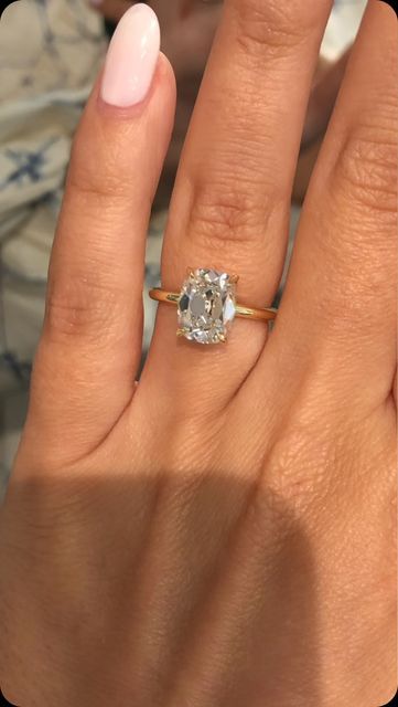 Ascot Diamonds Atlanta on Instagram: "This stunning!! engagement ring showcases an elongated cushion cut diamond in a timeless four-prong yellow gold solitaire setting. The delicate hidden halo and band highlights the diamond’s brilliance, creating an elegant and classic look perfect for Her who loves understated luxury. 🤍💕

—————————
#ascotdiamondsatlanta 

- 2.5 carat elongated cushion cut center
- set in all 18k yellow gold solitaire setting 
- with a classic hidden diamond halo 
- Shown on a size 5.5 finger

✨ Available at any of our locations

#ascotdiamonds #engagementring #cushioncutdiamond #taylorswift #solitaireengagementring #hiddenhalo" Elongated Old Mine Cut Engagement Ring, 5 Carat Elongated Cushion Cut, Elongated Cushion Ring, Cushion Cut Engagement Ring Gold, Gold Cushion Cut Engagement Ring, Elongated Cushion Cut Engagement Ring, Ascot Diamonds, Cushion Cut Solitaire, Elongated Cushion Cut