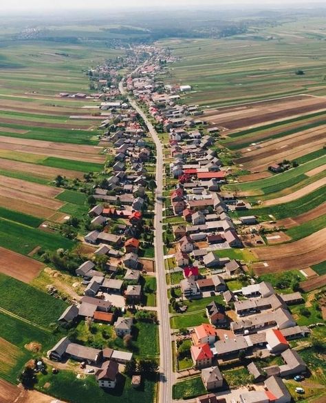 There's a town in Poland where all 6000 residents live on the same street In the Polish town of Suoszowa, all 6,000 residents live on the same street, creating a unique single-lane layout that stretches for over nine kilometers! Locals are said to cherish the charm and atmosphere of their one-of-a-kind town, potentially giving it an endearing sense of community. Monument Architecture, Visit Poland, Travel Facts, Aerial Images, Beautiful Streets, A Town, Fantasy Landscape, Abandoned Places, Small Towns