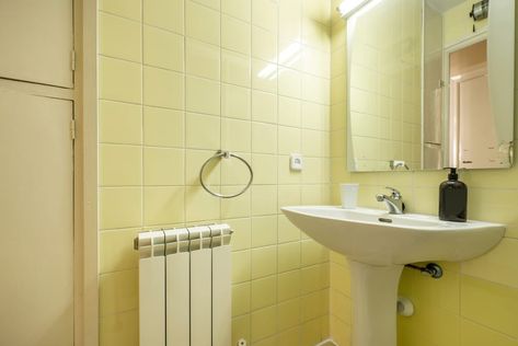 Bathroom with white wooden cabinets, glass-enclosed shower and square mirror above sink in vacation rental apartment Bathroom Knobs, Rental Bathroom, Picture Frame Molding, Fancy Lights, Shower Pan, Small Bath, Vintage Tile, Medicine Cabinet Mirror, Tiny Bathroom