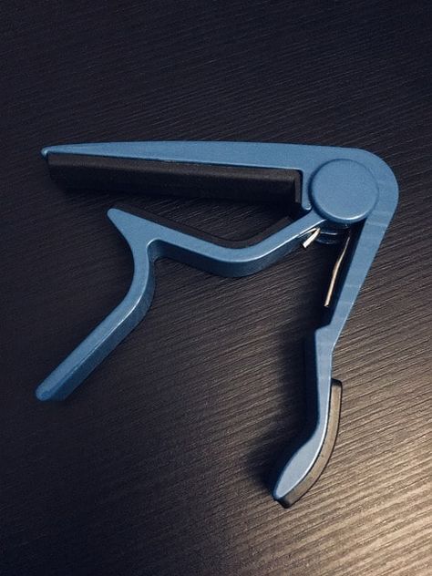 If you’ve watched a lot of people play guitar, you’re pretty likely to have come across at least some of them using a capo. This is an accessory that is Capo Guitar, Guitar Capo, Music Writing, Plastic Coating, Music Shop, Guitar For Beginners, Soft Plastic, Classical Guitar, String Instruments