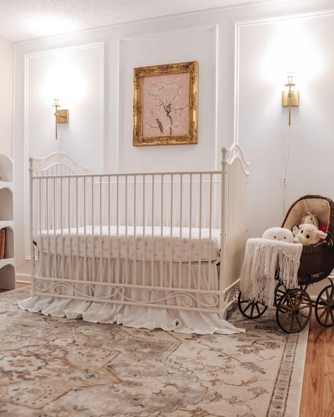 Ornate gold frames, wall sconces, and our Camellia crib make up the best nursery trio. @imbrianahill did an amazing job styling this elegant nursery! #girlnursery #homedecor #eleganthomes Vintage Gold Nursery, French Country Baby Nursery Ideas, Maeve Nursery, Elegant Baby Girl Nursery, Crib In Front Of Window, Gold Crib Nursery, Charlotte Nursery, Restoration Hardware Nursery, Classy Nursery