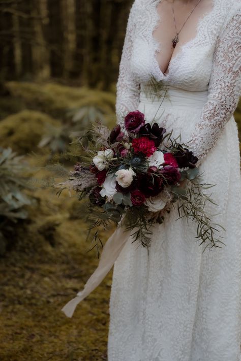 Bridal bouquet in deep reds, creams and greens. Whimsical and wild style handtied flowers. Tied with silk ribbon. Bride is standing in the forest holding the bouquet, wearing white lace wedding dress. Wild Wedding Bouquet, Scottish Elopement, Wedding Proposals, Elopement Wedding, Wedding Florals, Elope Wedding, Winter Wedding, Bridal Bouquet, Fall Wedding