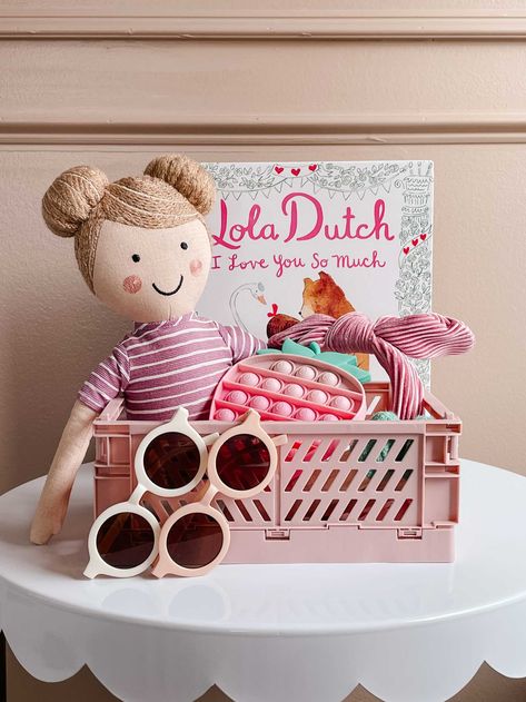 Create a Valentine's Day gift basket for your little sweetie! | aesthetic gift ideas, round kids sunglasses, strawberry pop it, velvet headband, pillowfort stuffed doll, cute foldable crate, collapsible crate, valentines day kids book Valentines Gifts Basket, Toddler Valentines Day Gifts Basket, Sweetie Aesthetic, Valentine Cookie Kit, Collapsible Crate, Diy Dollar Tree Gifts, Valentines 2024, Strawberry Pop, Valentine Cookie