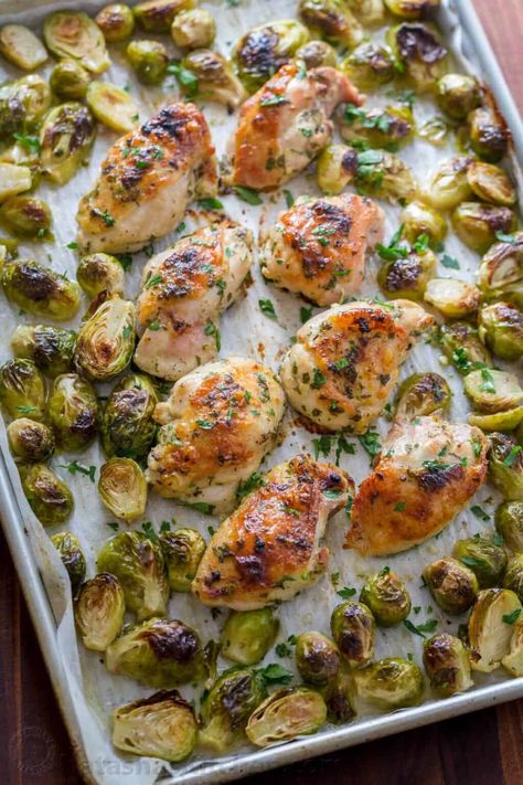 Winner winner chicken dinner! Baked Chicken thighs with a flavorful garlic, lemon and dijon marinade with brussel sprouts that baste in the scrumptious pan drippings. We just love this easy sheet pan chicken and brussels sprouts recipe! Learn our secrets to marinating chicken and how to trim brussel sprouts. | natashaskitchen.com Roasted Boneless Chicken Thighs, Chicken Brussels Sprouts, Chicken And Brussels Sprouts, Chicken Brussel Sprouts, Easy Sheet Pan Chicken, Marinating Chicken, Baked Brussel Sprouts, Dijon Chicken, Chicken Crockpot Recipes Easy