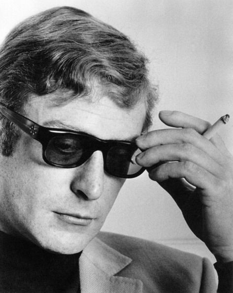 Micheal Caine with a cigarette in his hand during an interview Michael Caine Young, Boy Photo Shoot, Peter O'toole, Michael Caine, Baby Boy Photos, Princess Margaret, Healthy People, Best Selling Books, Square Sunglasses Men