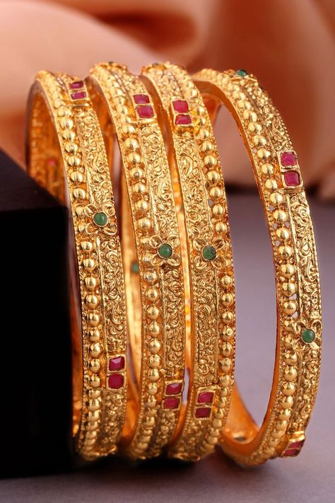 Set of four 24K gold-plated red and green stone-studded handcrafted bangles, has filgree design detailing. . . bangles #bangleslove #handcraftedbangles #goldlove Nose Accessories, Antique Necklace Gold, Plain Gold Bangles, Filigree Bangle, 22k Gold Bangles, Gold Earrings For Kids, Gold Bangles Indian, Gold Bangles For Women, New Gold Jewellery Designs