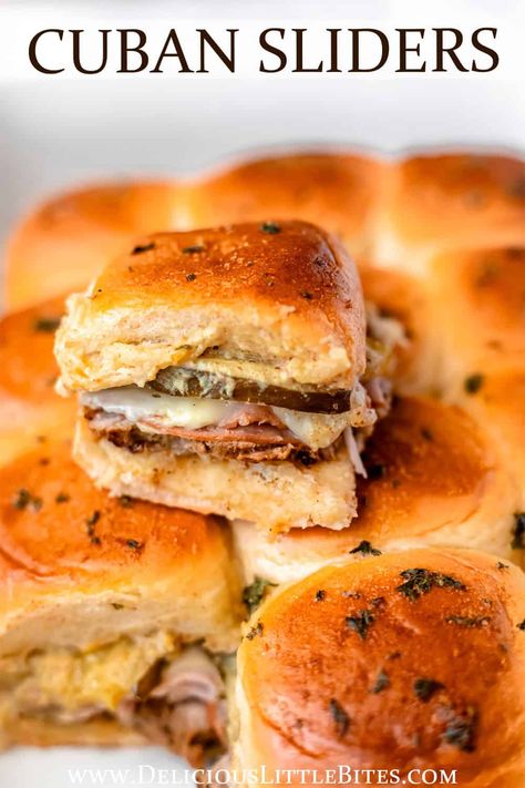 Cuban Sliders, made with traditional Cubano sandwich ingredients, will hit the spot every time. This recipe is a quick, fun appetizer or snack that is full of flavor from roasted pork, ham, Swiss cheese, pickles and mustard. A brush of butter and herbs creates a delicious garlic bread flavor on top of the sweet Hawaiian rolls they are made on. Cuban Sandwich Sliders Kings Hawaiian, Cubano Sliders Hawaiian Rolls, Cuban Recipes Sandwich, Hawaiian Roll Cuban Sliders, Roll Sandwiches Kings Hawaiian, Hawaiian Bread Recipes Sandwiches, Ruben Sliders Hawaiian Rolls, Cubano Sandwiches Recipe, Pulled Pork Hawaiian Rolls Sliders