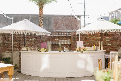 We just can’t get enough of this beautiful Race and Religious summer wedding with Lovegood Rentals! The outdoor setup with semi circle bar, tassel umbrellas, and custom cocktails to make for an unforgettable event! Lovegood Wedding & Event Rentals | Featuring Collection : Madison White Bar, Florence Back Bar, Tassel Umbrellas, Pub Tables, Bentwood Chairs | Vintage Furniture & Decor Semi Circle Bar, Wedding New Orleans, Circle Bar, Chairs Vintage, Pub Tables, Blush Wedding Flowers, Custom Cocktails, Religious Wedding, White Bar