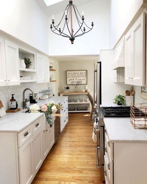 How amazing is this farmhouse alley kitchen? I love how bright and clean it all feels! The fresh flowers, gorgeous modern farmhouse chandeliers, and pretty counter tops are my favorites! #kitchen #kitchendesign #kitchenideas #home Alley Kitchen, Small Galley Kitchen Remodel, White Galley Kitchen, Galley Kitchen Remodel Ideas, Small Galley Kitchen, Galley Kitchen Design, Galley Kitchen Remodel, Galley Kitchens, Galley Kitchen