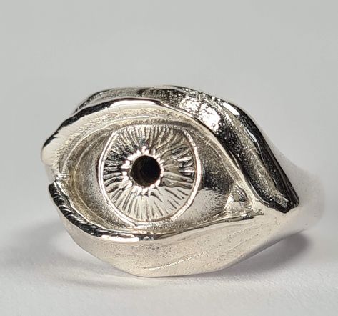 **Please note that we dispatch on Tuesdays unless special delivery express option is paid for** Sterling silver eye ring. Original design carved in wax then lost wax cast into solid sterling silver.  Available without a gemstone, with synthetic sapphire, synthetic emerald, garnet, black spinel, amethyst or any other gem by request. First class signed for post included for UK mainland orders. Wax Casted Rings, Wax Cast Ring, Wax Ring Carving, Lost Wax Ring, Wax Ring Carving Ideas, Lost Wax Casting Rings, Silver Eye Ring, Wax Carved Ring, Strange Rings