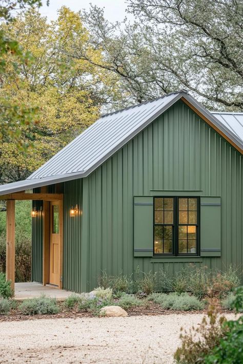 Compact metal home with a green exterior and a gable roof. Feast your eyes on the quirky charm, economic genius, and sturdy flair packed into small metal building homes, where industrial meets cozy! Metal Shop Building With Loft, Metal Siding And Roof Colors, Barndominium With Gable Porch, Multi Building Home, Colony Green Metal Building, Galvalume Metal Roof House, Green Metal Building, Green Metal Roof Houses Color Combos, Green Metal House