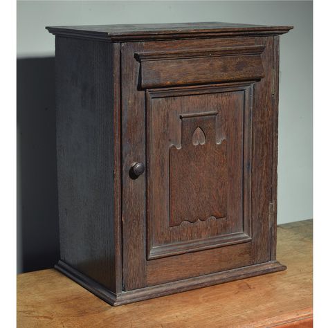 Charles Francis Annesley Voysey (1857 - 1941) A DESKTOP CABINET oak, the panelled hinged door carved with an upturned heart motif, enclosing an open shelf and pigeon holes 39cm. high by 32.5cm. wide by 20cm. deep; 1ft 3 1/4 in., 1ft ¾in, 8in. early 20th century English Arts And Crafts, Arts And Crafts Era, Antique Wallpaper, Arts And Crafts Furniture, Beauty In Art, Heart Motif, English Art, 20 Century, Textile Designs