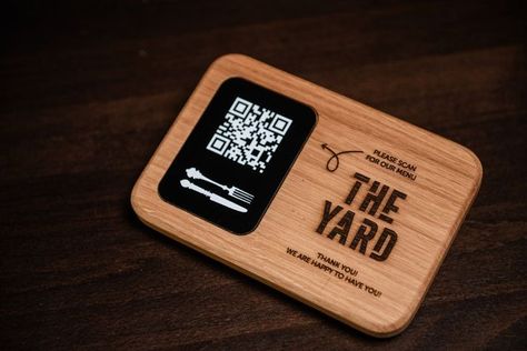 An oak stand that holds an acrylic tablet with your QR code. We are engraved on your logo on wood, printed on acrylic. The information on the photo is approximate, we can develop a design at your request. Such a QR code mark by electronic scanning can lead customers to your menu web page. In a pandemic, this is a great way to minimize your visitors' contact with surfaces where the virus might be. Menu Qr Code, Wood Menu, Moon Cafe, Qr Code Sign, Name Plate Design, Menu Printing, Professional Business Card Design, Menu Sign, Laser Cut Wood Crafts