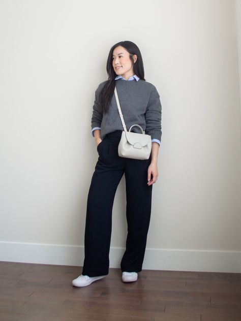 Sharon of Her Simple Sole is showcasing a outfit wearing one of her new Everlane staples, featuring a grey sweater, a blue relaxed button up shirt, black wide-leg pants, an off-white crossbody bag and white sneakers | minimalist outfits | simple outfit ideas Button Up Shirt Layering, White Button Down Shirt Under Sweater, Blue Shirt Outfit Winter, Button Down Sweater Outfits, Casual Wide Leg Pants Outfit, Shirt Under Sweater Outfit, Blue Wide Leg Pants Outfit, Leather Pants Outfit Winter, Shirt Under Sweater