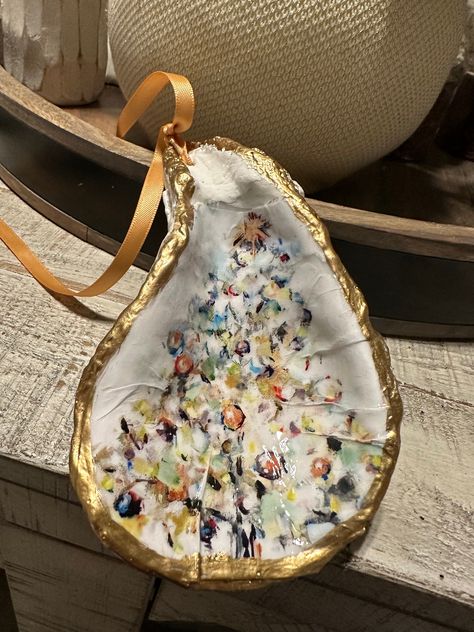 You are looking at beautiful Colorful Christmas Tree Oyster shell ornament trimmed in gold leaf.  These ornaments come with beautiful ribbon and the backs are finished in white.  The size and shape of each oyster vary in size from 3 inches to 5 inches. Also available in an oyster dish or coasters. Please message us for more info. Angela Core, Oyster Cross, Oyster Shell Ornaments, Oyster Art, Oyster Ornament, Oyster Shell Crafts, Beachy Christmas, Nyc Christmas, Shell Decorations