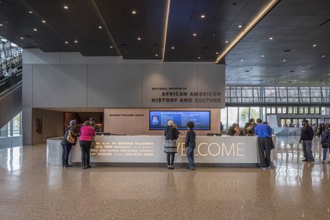 Gallery of Adjaye's National Museum of African American History & Culture Photographed by Brad Feinknopf - 29 Museum Welcome Desk, Museum Ticket Counter Design, Museum Reception Design, Museum Lobby Design, Museum Entrance Design, Museum Office, Museum Lobby, Museum Exhibition Design Display, Museum Reception