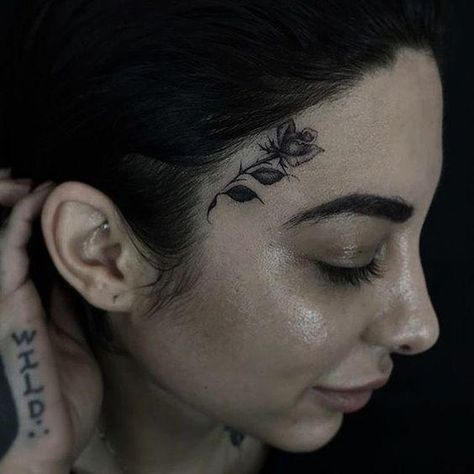 10 Tasteful Face Tattoos For Women & Their Meanings Tattoo Above Eyebrow, Hawaiian Tattoo Meanings, Girl Flower Tattoos, Small Face Tattoos, Delicate Face, Face Tats, Face Tattoos For Women, Small Rose Tattoo, L Tattoo