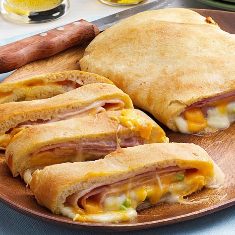 Ham and Cheese Loaf Recipe -This golden loaf relies on the convenience of refrigerated dough that's stuffed with ham and cheese. I created the recipe by experimenting with a few simple ingredients my family loves. It makes a delicious hot sandwich in no time. —Glorida Lindell, Welcome, Minnesota Ham And Cheese Loaf, Pizza Loaf Recipe, Cheese Stromboli, Cheese Loaf, Pepperoni Bread, Cheese Crust Pizza, Stromboli Recipe, Frozen Bread Dough, Cheese Crust