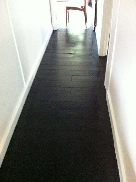 I love these black wood floors. I could find some cheap flooring,sand it and stain it matte black on the cheap. It would look beautiful with the white slip covered sectional,white walls and white appliances. <3 Painted Plywood Floors, Black Flooring, Painted Hardwood Floors, Black Marble Floor, Black Wood Floors, Old Wood Floors, Flooring Texture, Painted Wood Floors, Floor Paint