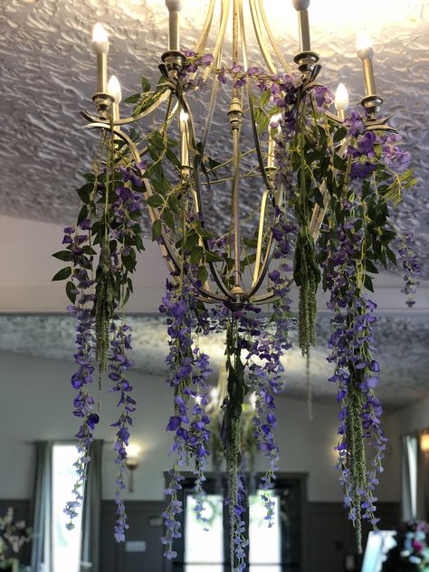 A touch of purple wisteria added to the reception at the Landoll’s Mohican Castle Wisteria Wedding Flowers, Wisteria Wedding Theme, Hanging Wisteria Decor, Hanging Wisteria Wedding, Purple Wisteria Wedding, Wisteria Chandelier, 18th Ideas, Hanging Wisteria, Lavender Theme