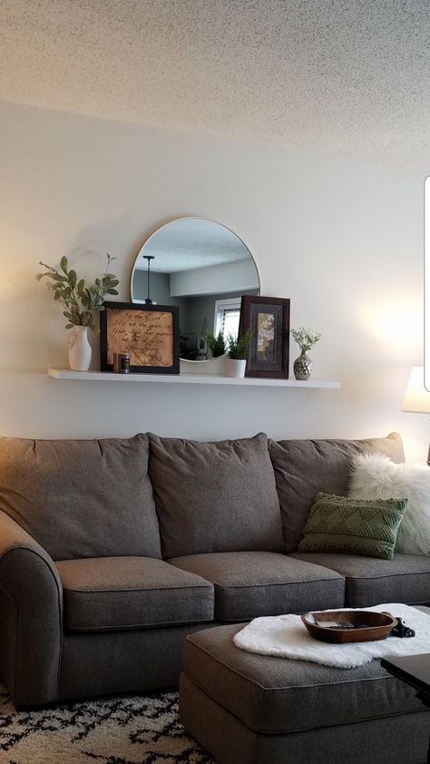 Floating Wall Shelves Above Couch, Mirror Shelf Living Room, Over The Couch Wall Decor Ideas Modern, Floating Shelves With Mirror Living Room, Long Floating Shelf Above Sofa, Above The Couch Wall Decor Modern, Mirror Wall Decor Above Couch, Behind The Couch Mirror, Living Room Aesthetic Plants