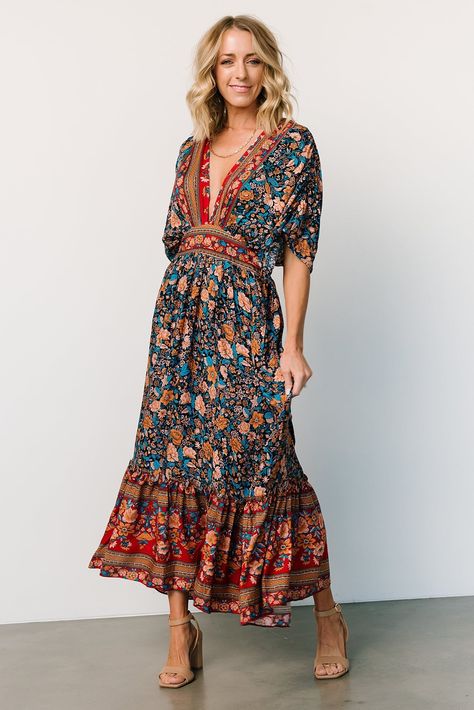 Baltic Born exclusive style Navy with rust, peach, teal, and red accents Boho border floral print throughout Easy-to-wear, lightweight material Surplice neckline Gathered detailing at bodice Short, flowy sleeves with ruching Keyhole closure at back neck High waistline with smocking at back Functional side pockets Flowing midi-length skirt 100% Rayon Sierra is 5’8, cup size 37”, size 6/8 and wearing size L Trina is 5'6, cup size 32D, size 2 and is wearing size S Hipster Outfits For Women, Boho Border, Blue Satin Dress, Midi Dress Navy, Baltic Born, Velvet Maxi Dress, Hipster Outfits, Flowy Sleeves, Surplice Neckline