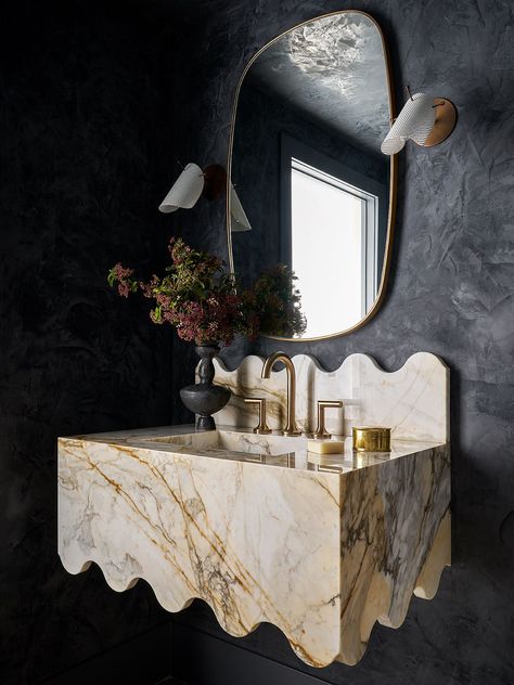 The seemingly melted marble sink, gold accents, and dark lime washed walls create a dramatic, luxurious statement in this bold powder room. Powder Room Sink, Marble Vanity, Marble Sinks, Powder Bath, Amber Interiors, Plaster Walls, Interior Inspo, Bathroom Inspiration, Powder Room